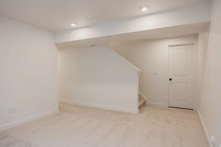 Neutral-toned wall-to-wall carpeting throughout