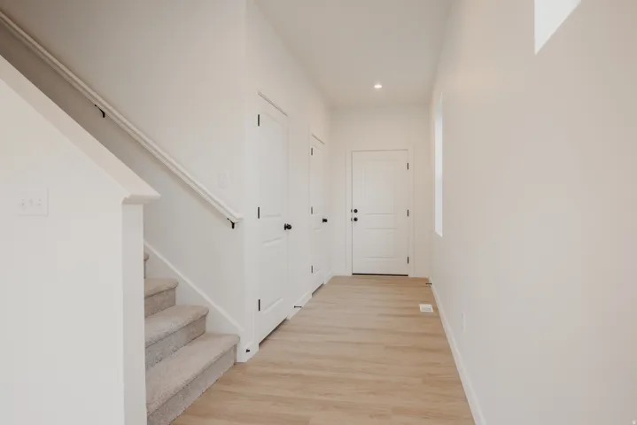 Entryway featuring light wood-finish flooring and a neutral color palette