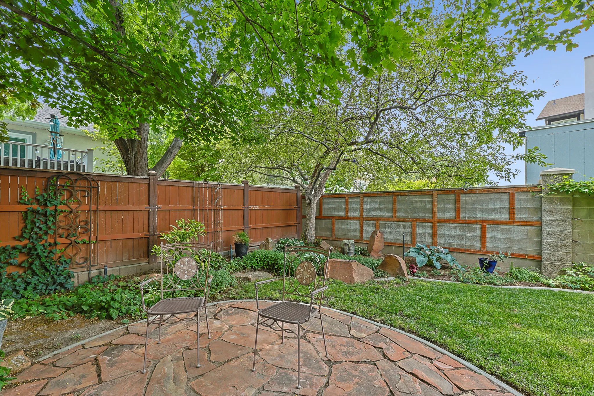 Expansive backyard featuring a natural flagstone patio
