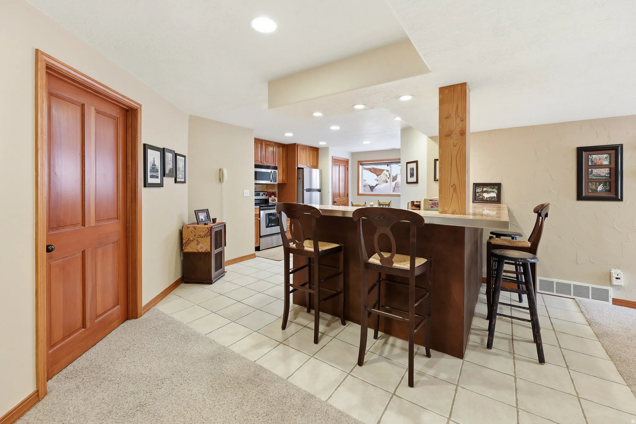 Spacious open floor plan living room / recreation room / kitchen with breakfast bar