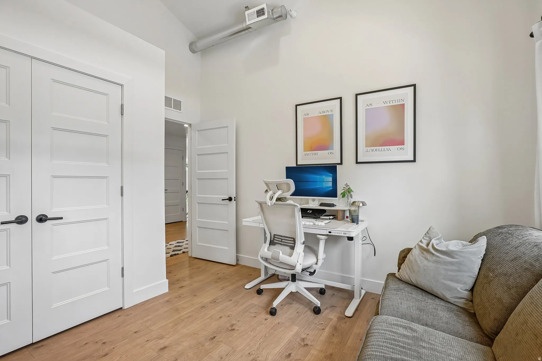 Light wood-finish flooring complements the neutral wall color