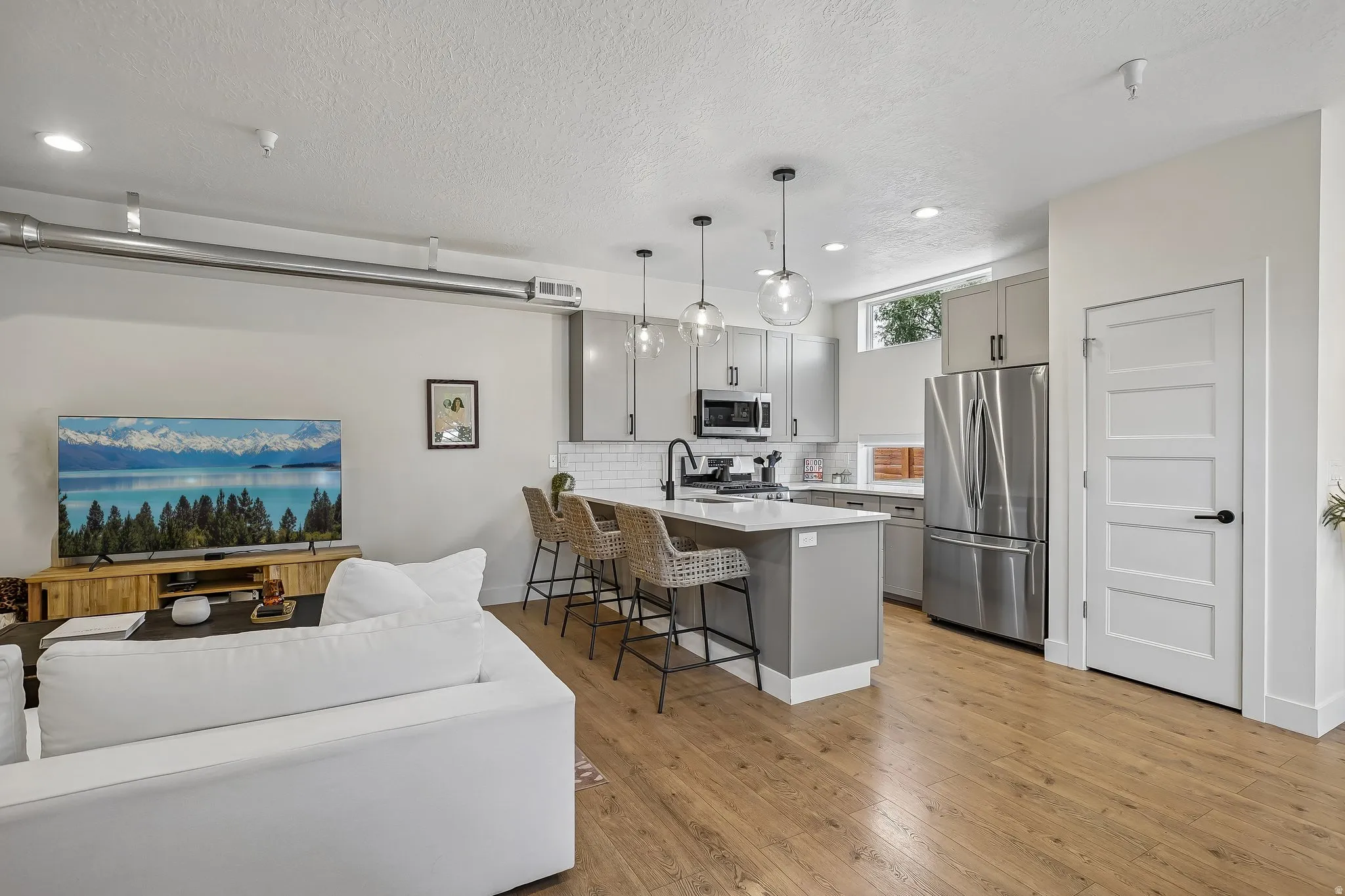 Open concept living space featuring wood-finish flooring