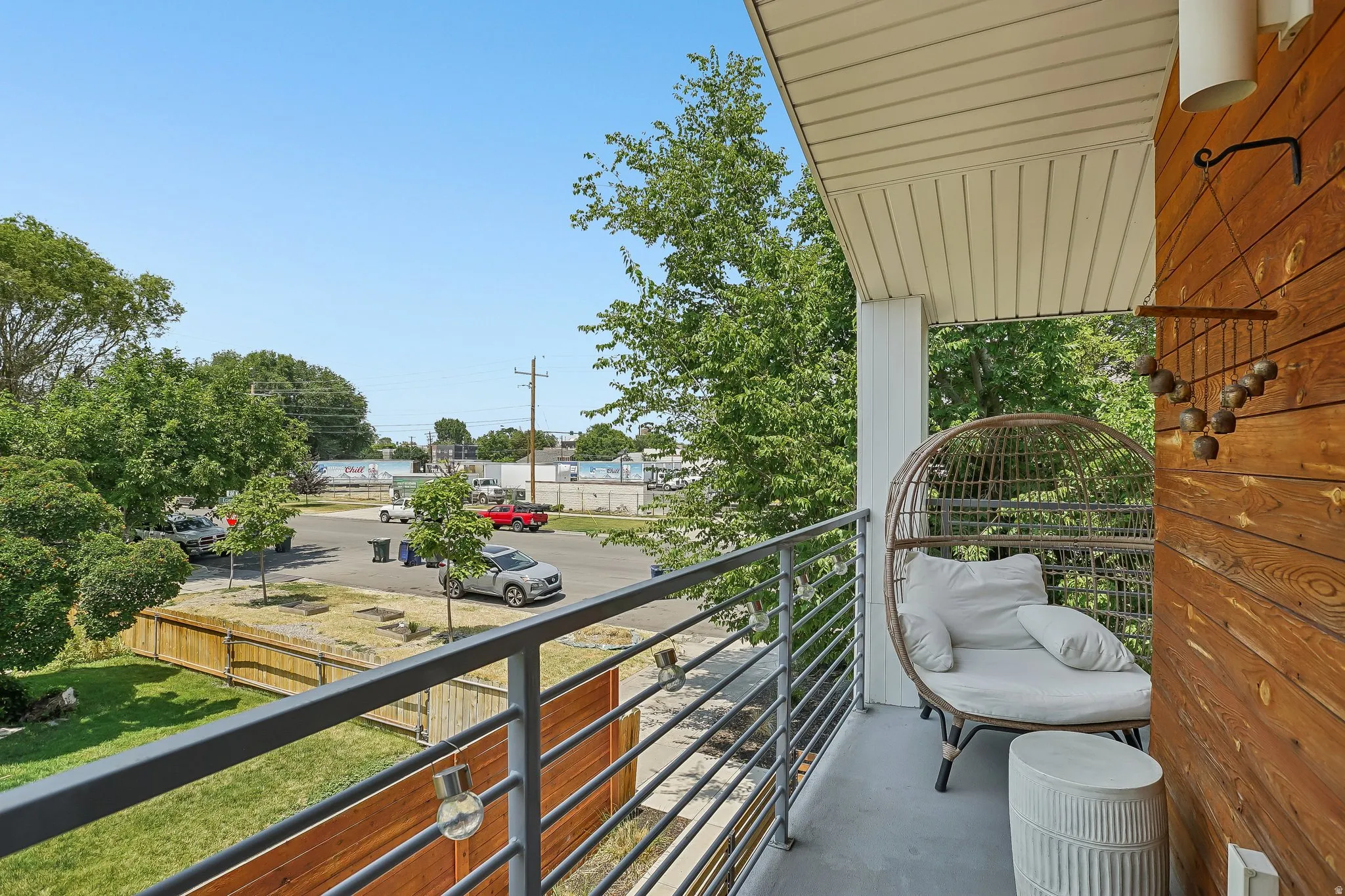 Balcony featuring a horizontal wood plank accent wall, a white support pillar, and a white soffit ceiling