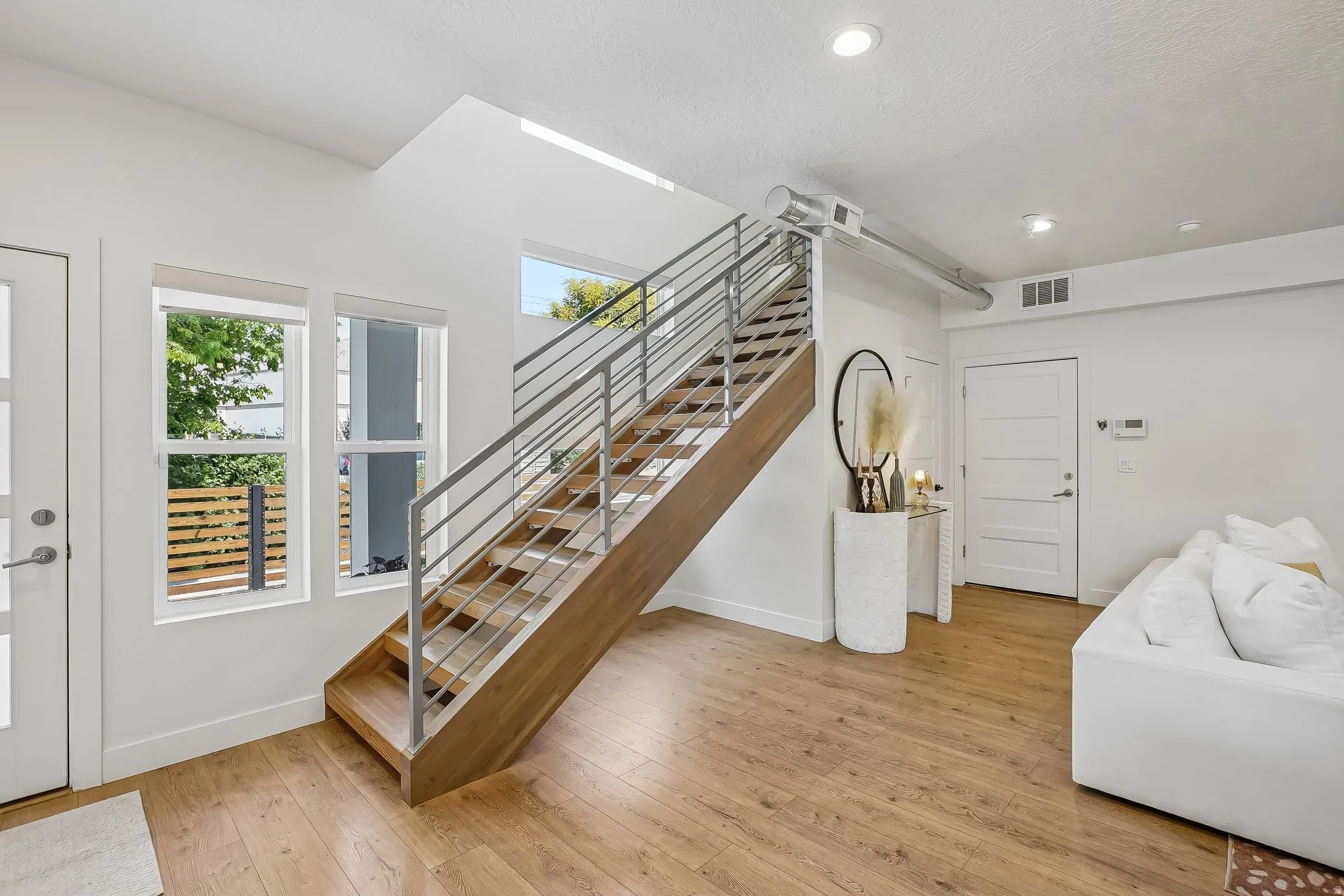 Modern staircase with wood-finish treads and metal railings