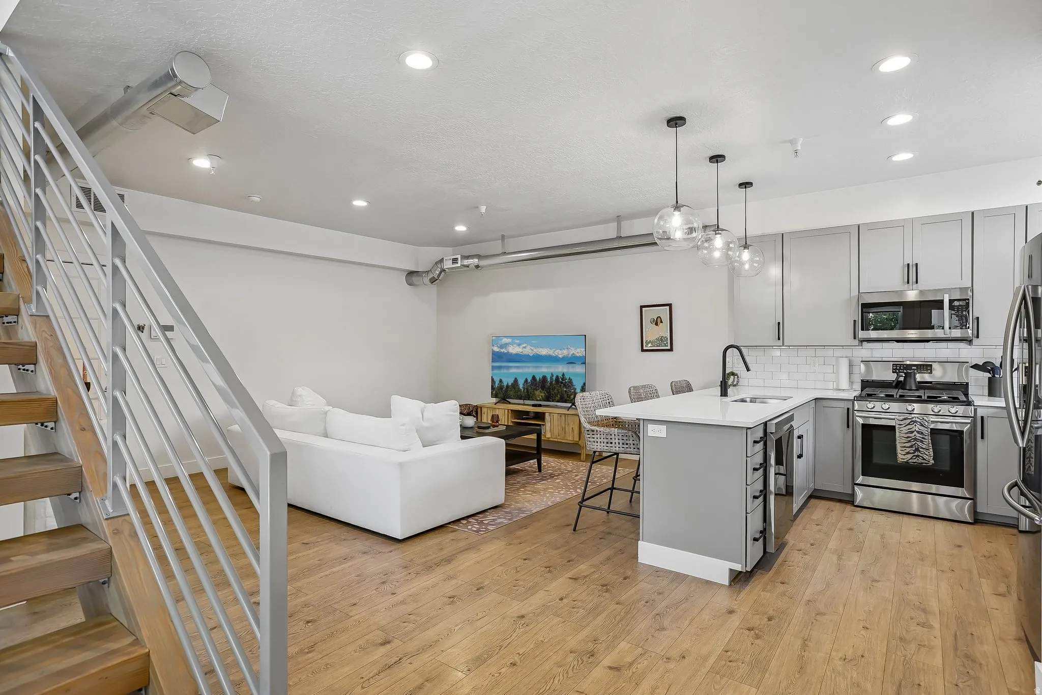 Open concept living area featuring wood-finish flooring