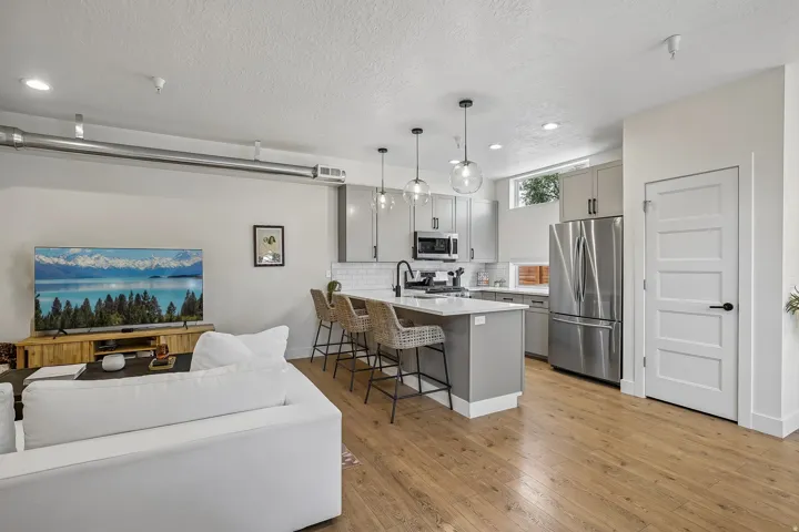 Open concept living space featuring wood-finish flooring