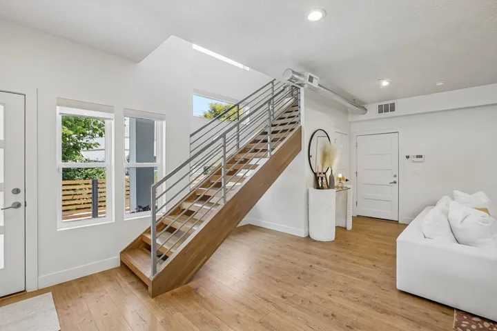 Modern staircase with wood-finish treads and metal railings
