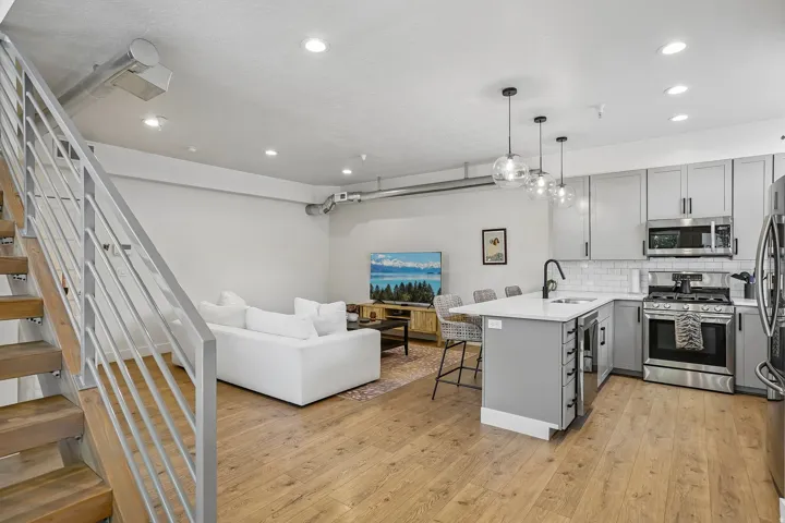 Open concept living area featuring wood-finish flooring