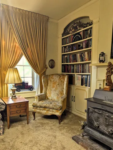 Built-in arched bookshelf cabinetry with lower storage