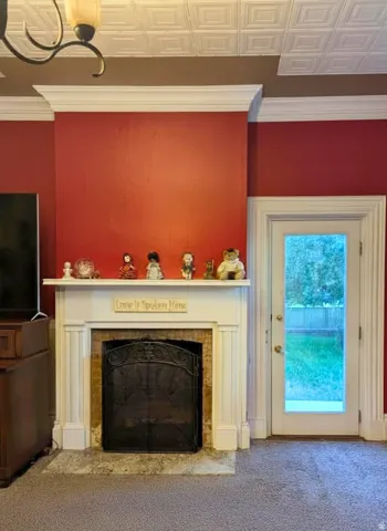 Master bedroom Fireplace featuring a white mantel, brick surround, and decorative screen