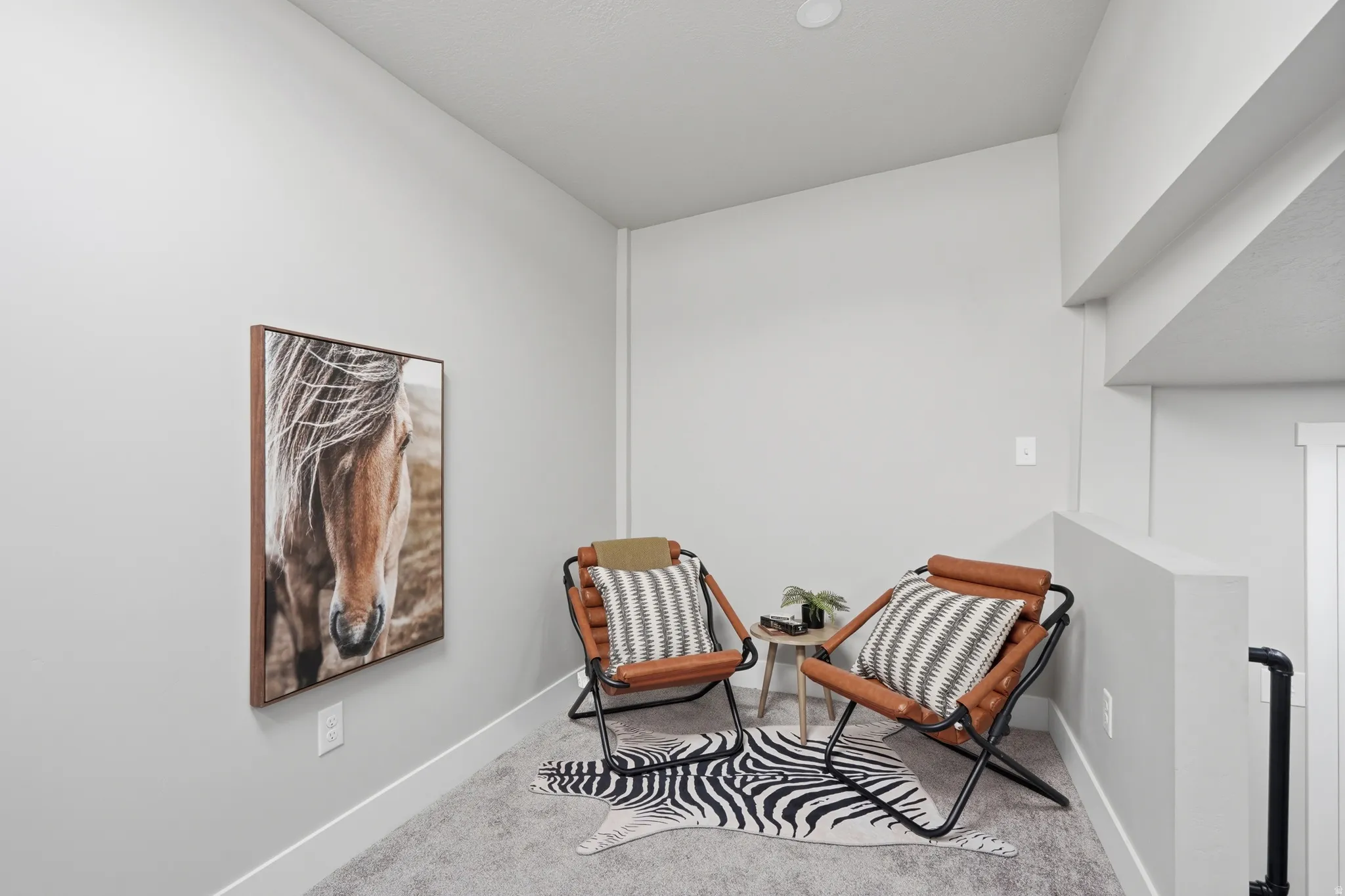 Carpeted alcove featuring light gray walls, white trim, and a recessed ceiling light