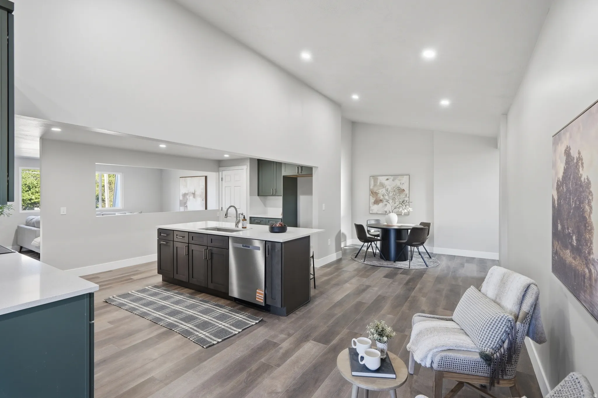 Kitchen island with dark cabinetry and a stainless steel dishwasher, contrasting with light countertops