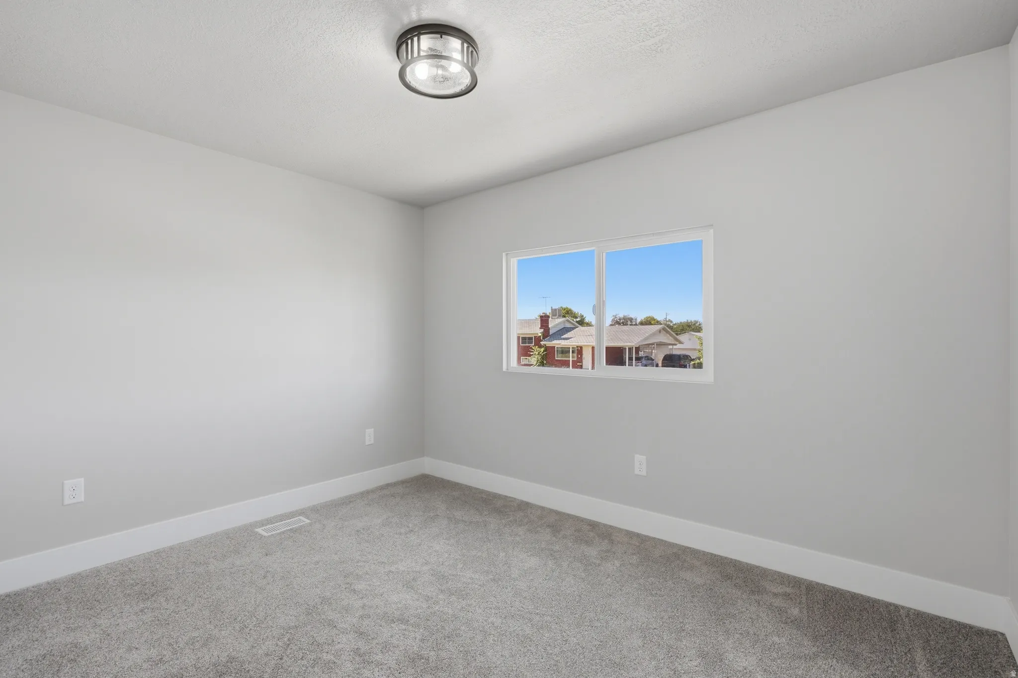 Neutral gray wall paint, white trim, and gray carpet