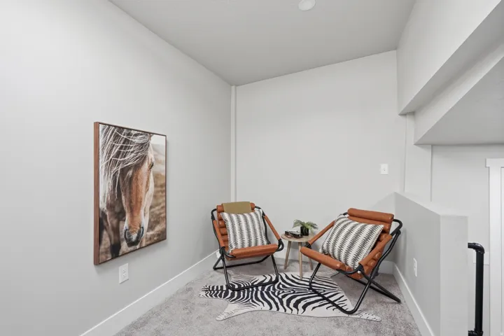 Carpeted alcove featuring light gray walls, white trim, and a recessed ceiling light