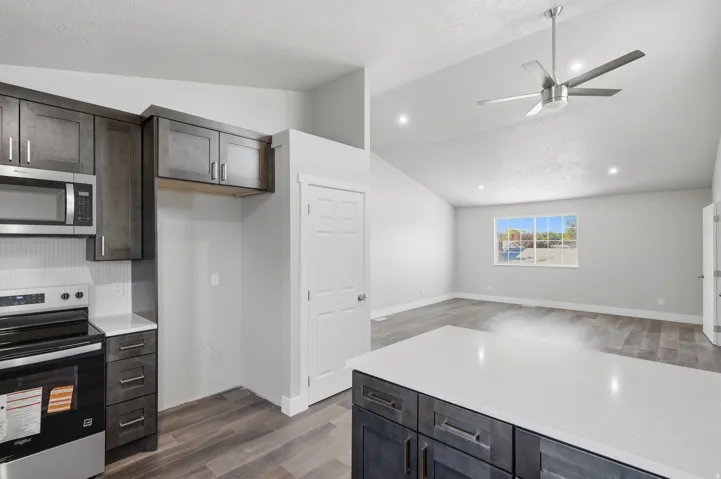 Open concept living space featuring a modern kitchen island with a white countertop