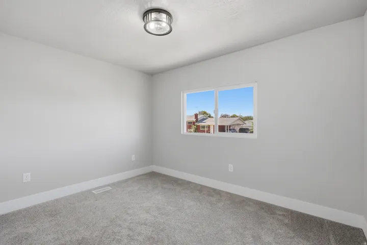 Neutral gray wall paint, white trim, and gray carpet