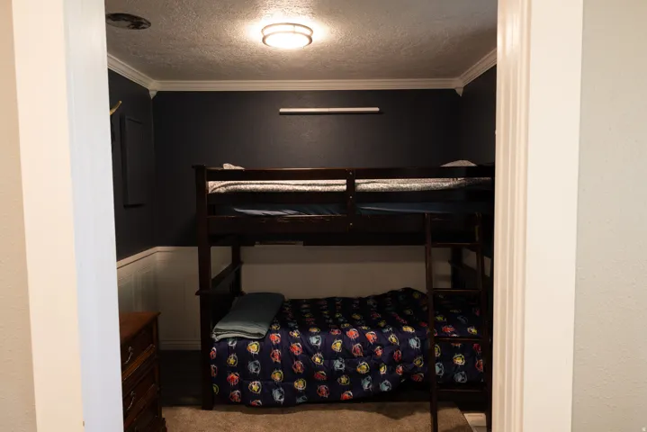 Compact room featuring dark wall paint and wainscoting