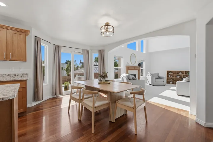 Dining area featuring wood-finish flooring and a contemporary overhead light fixture