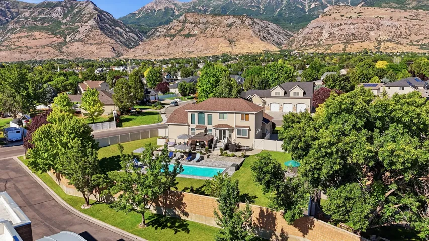 Rear exterior featuring a swimming pool, paved patio, and a covered pergola