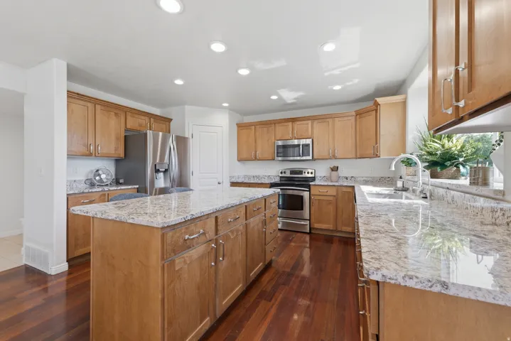 Kitchen featuring wood-finish flooring, recessed lighting, and light wood cabinetry with brushed nickel hardware