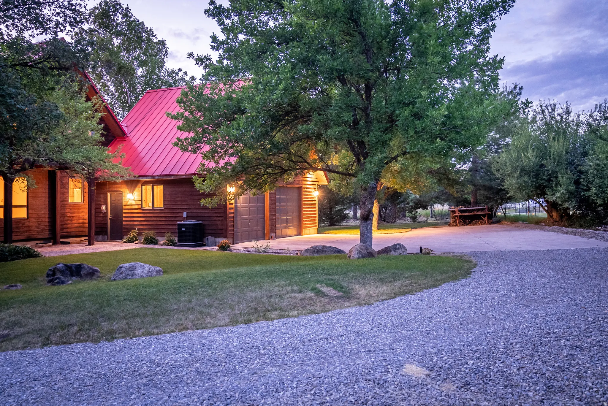 Rustic-style residence featuring a red metal roof and wood siding