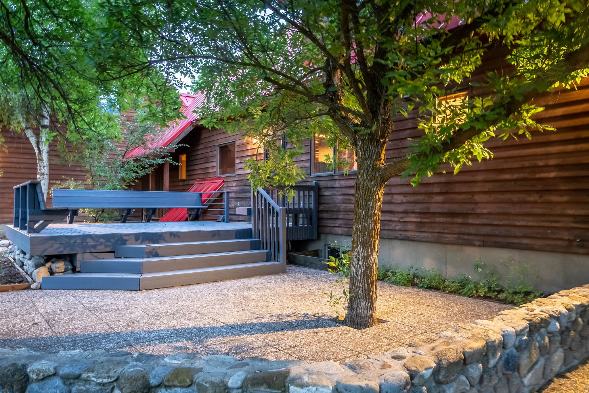 Exterior wood siding with red gabled roofing