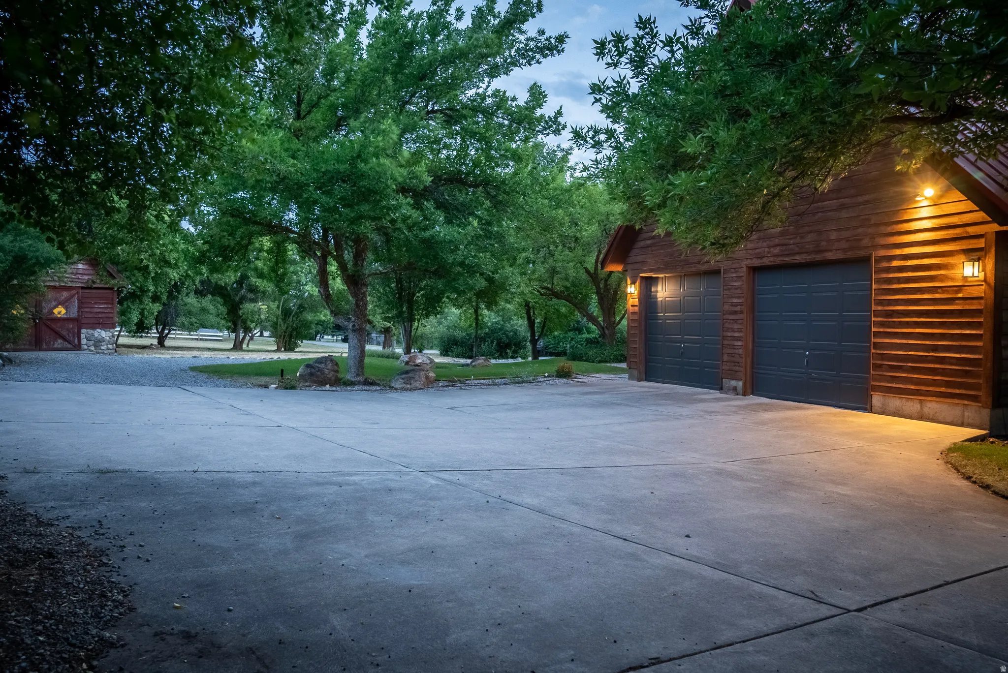 Two-car garage featuring horizontal wood siding and panel garage doors