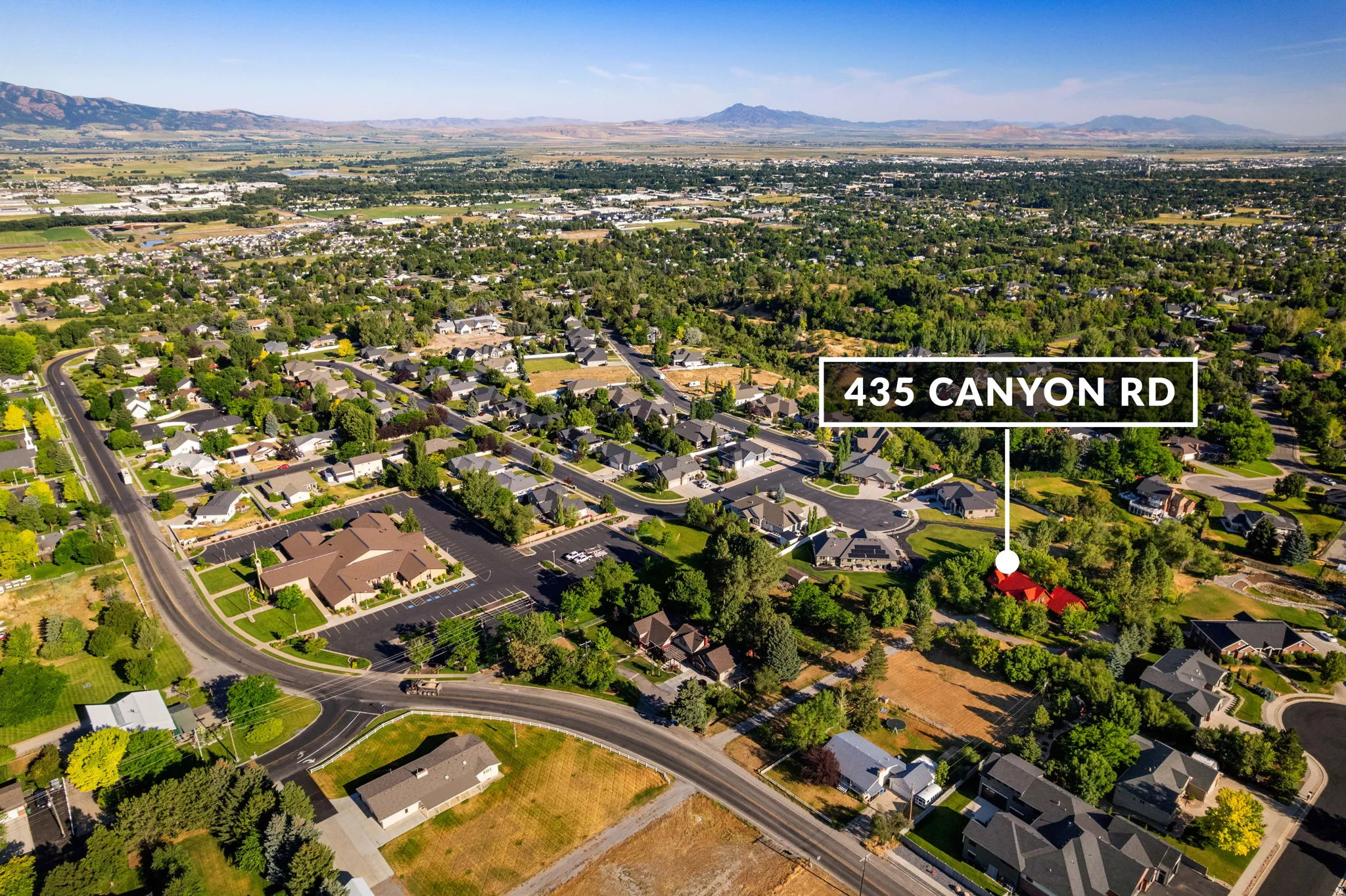 Expansive aerial perspective showcasing a residential neighborhood with varied housing styles and mature trees