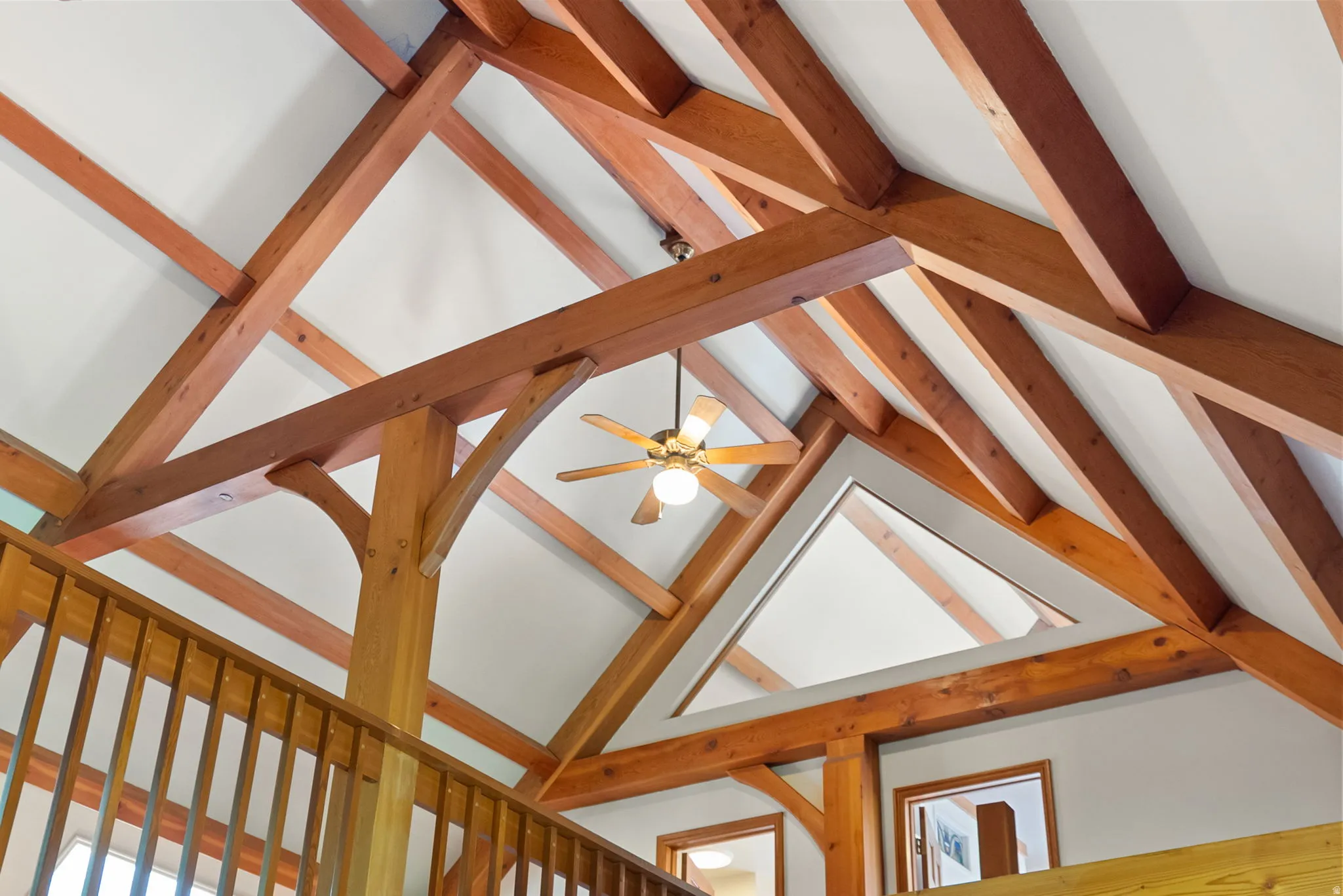 Vaulted ceiling featuring exposed wood beams and white panels