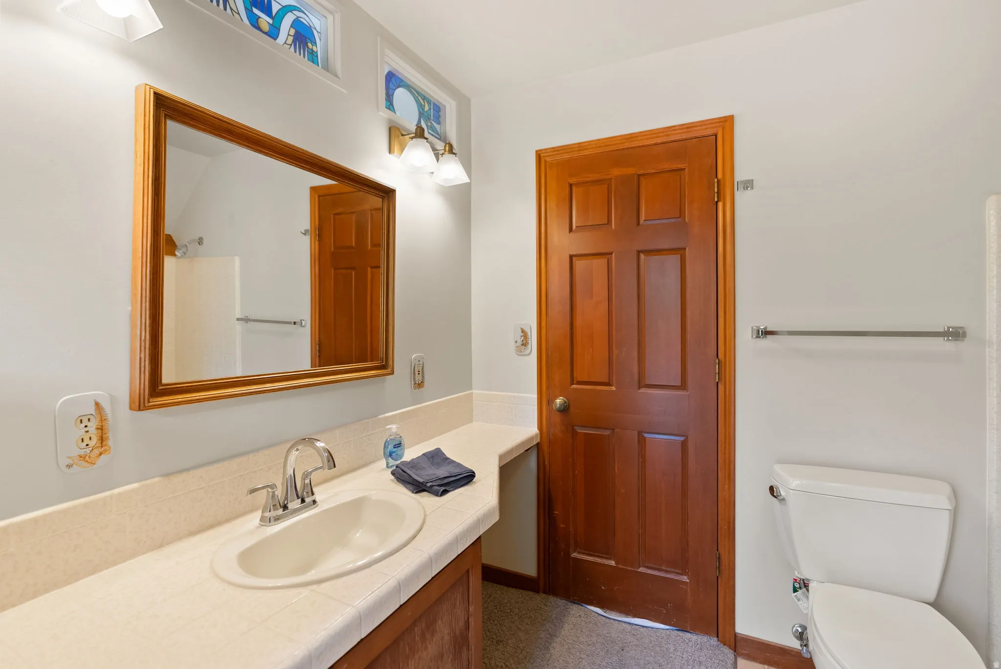 Bathroom vanity with a tiled countertop and integrated sink