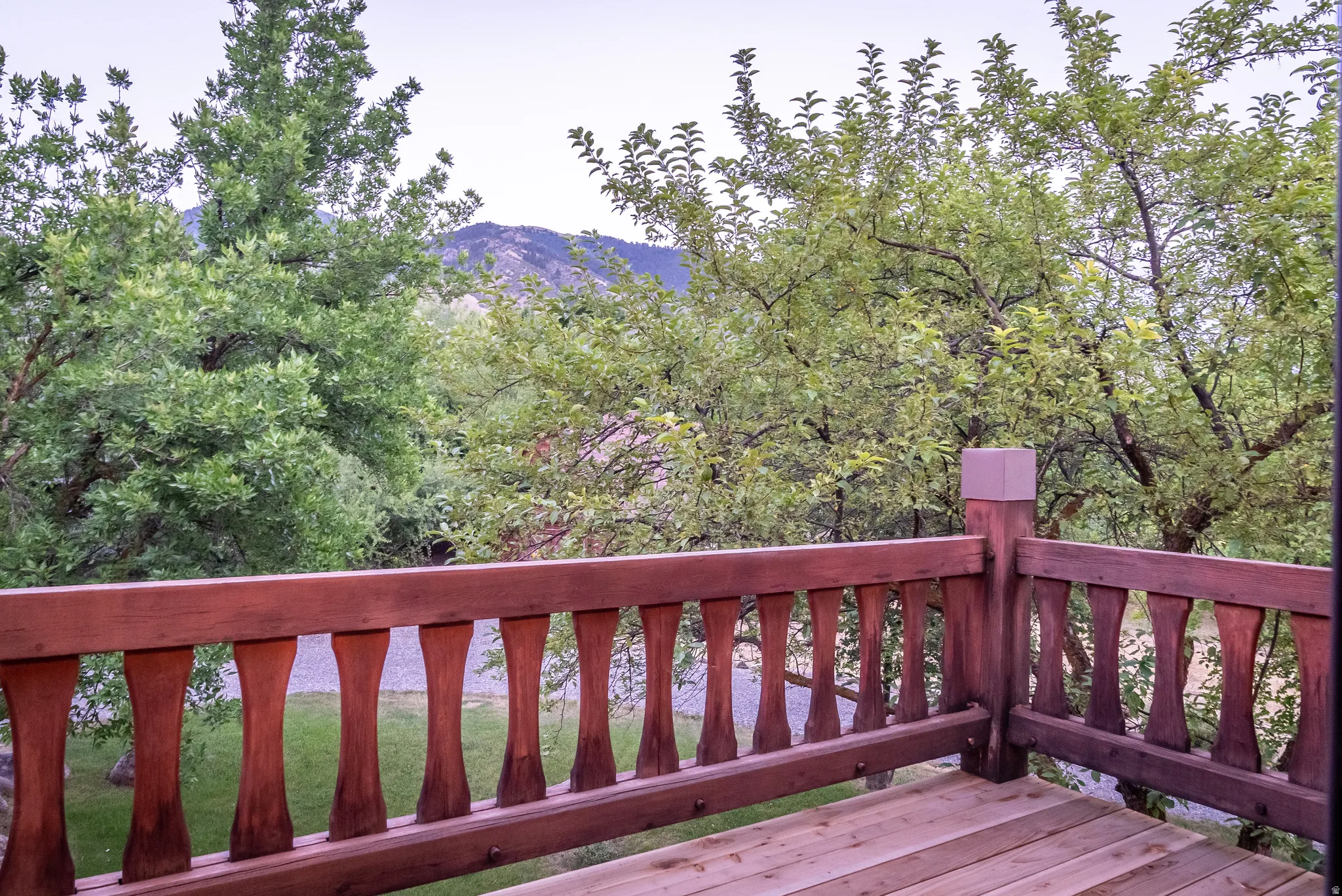 Wood-finish deck with a decorative baluster railing