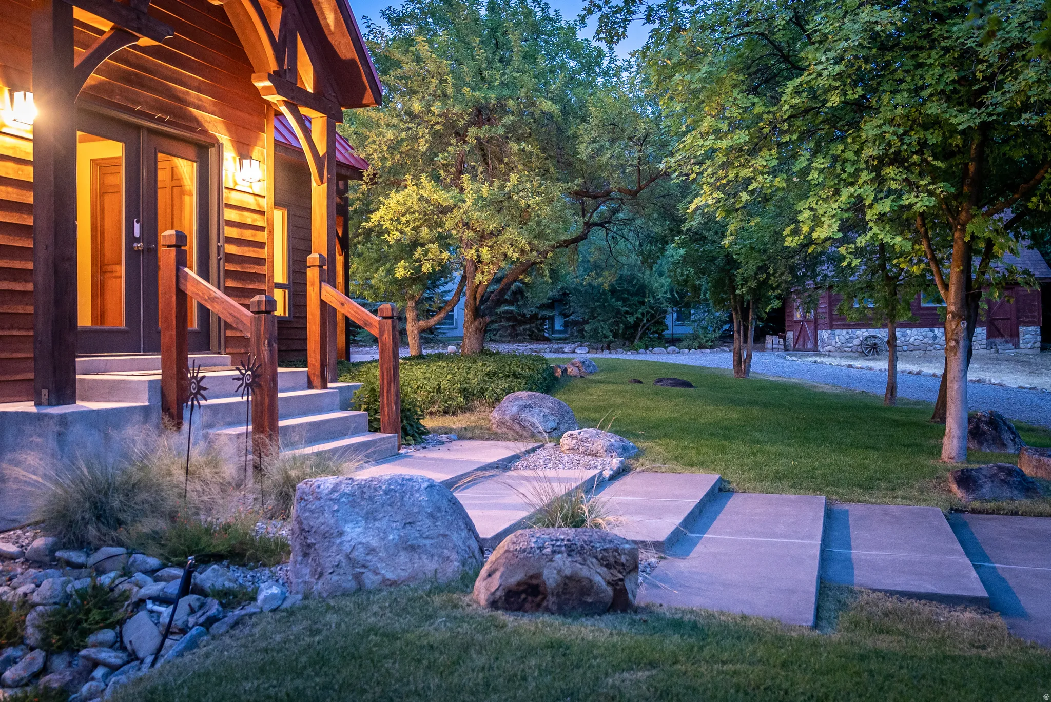 Wood-sided exterior featuring a covered porch with exposed timber framing and double glass-panel entry doors