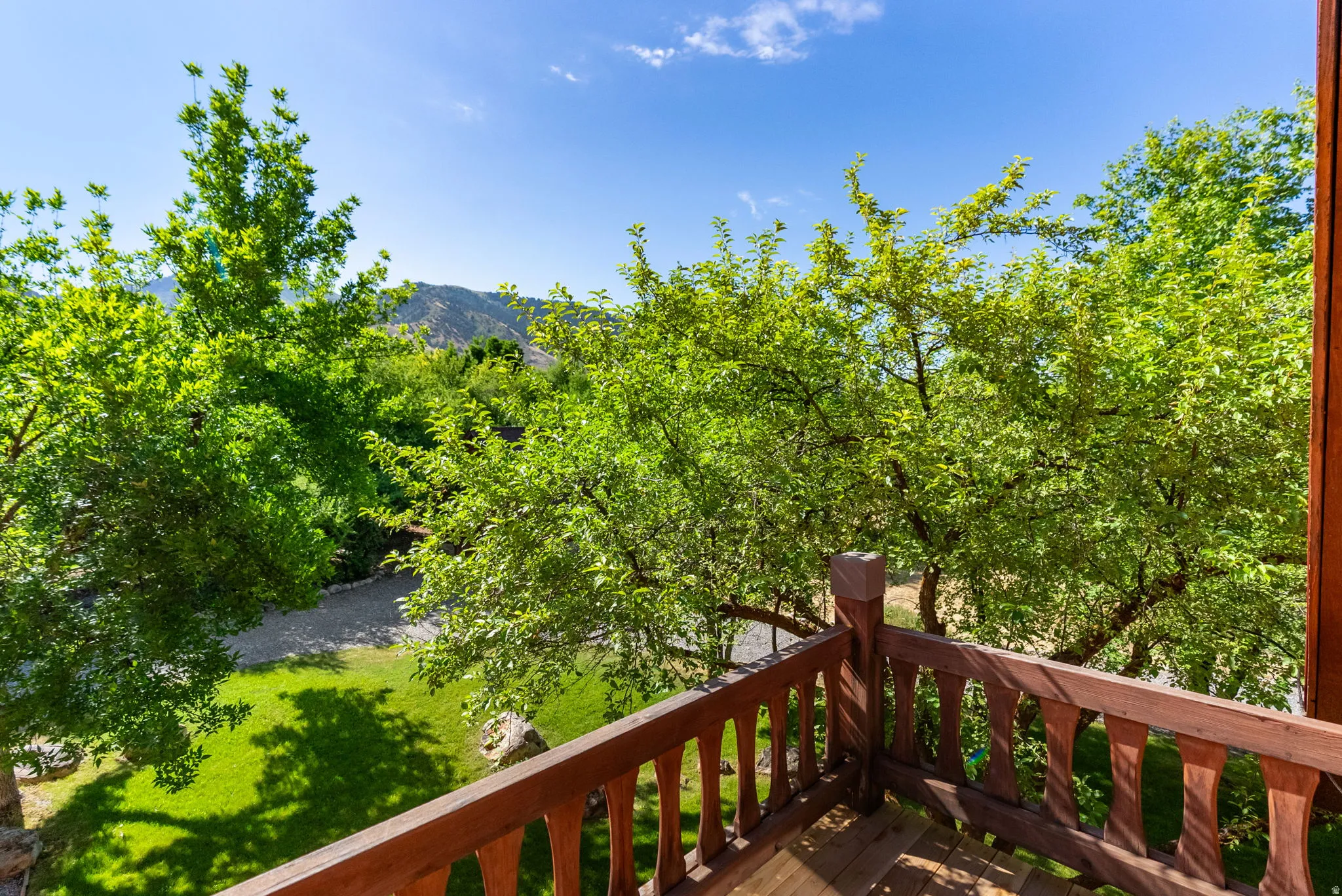 Balcony featuring wood-finish railing and flooring
