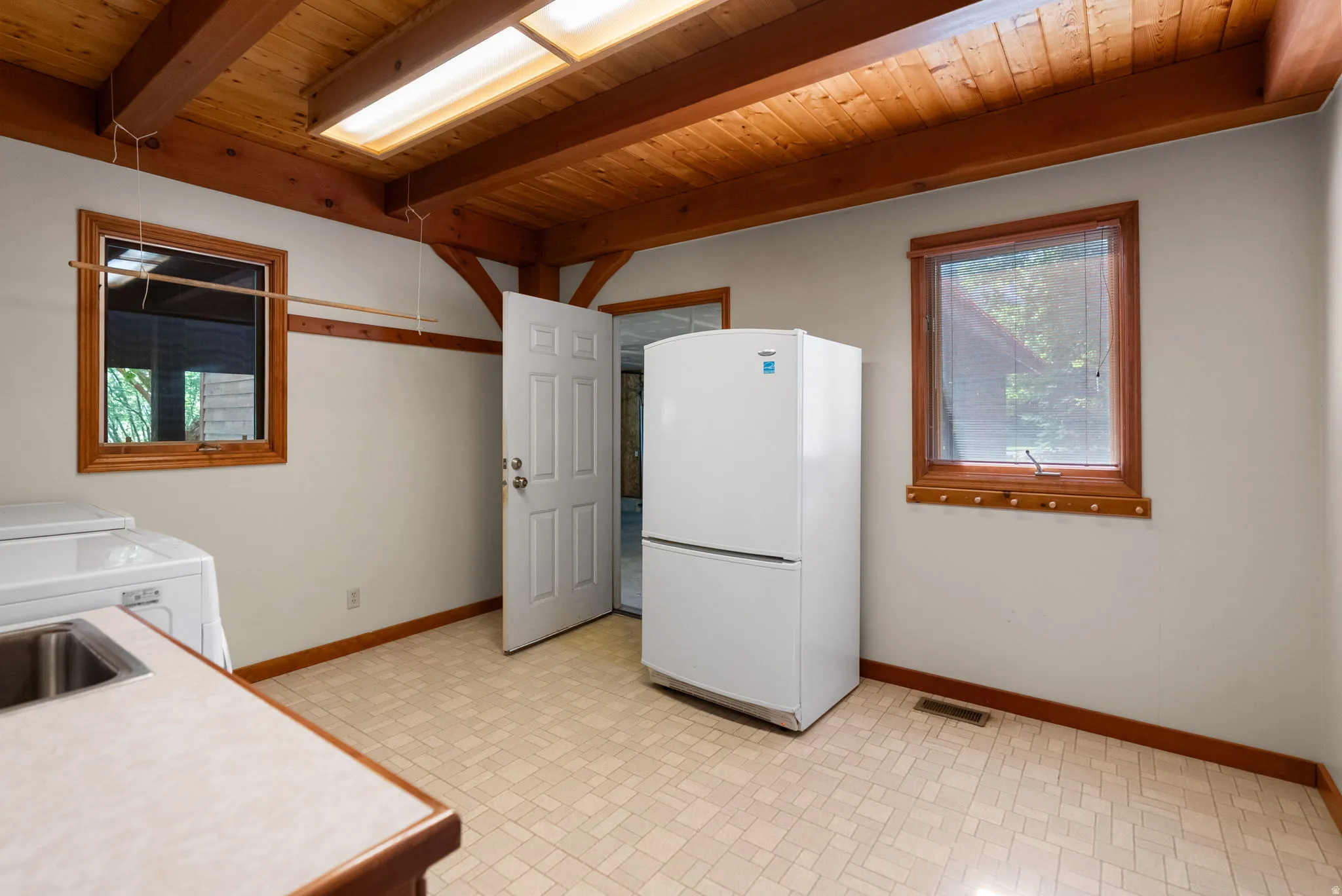 Wood-beamed ceiling with an integrated skylight and exposed wood supports