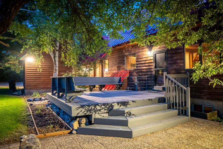 Spacious outdoor deck with tiered stairs and wood-finish railing