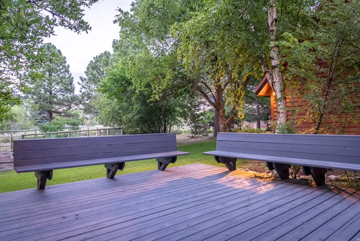 Expansive outdoor deck featuring wood-finish flooring and two built-in benches