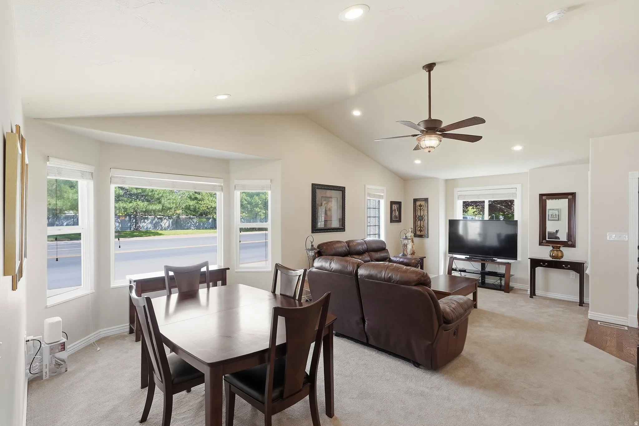 Vaulted ceilings complement an open-concept living area with bay windows
