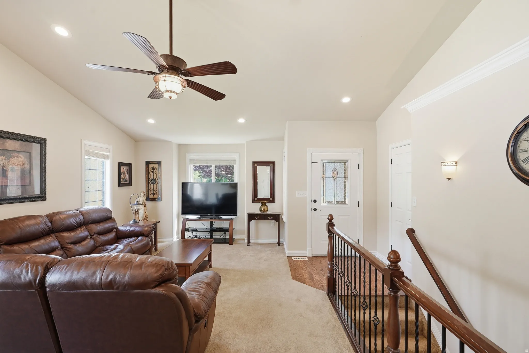 Living room with vaulted ceiling, recessed lighting, and a ceiling fan