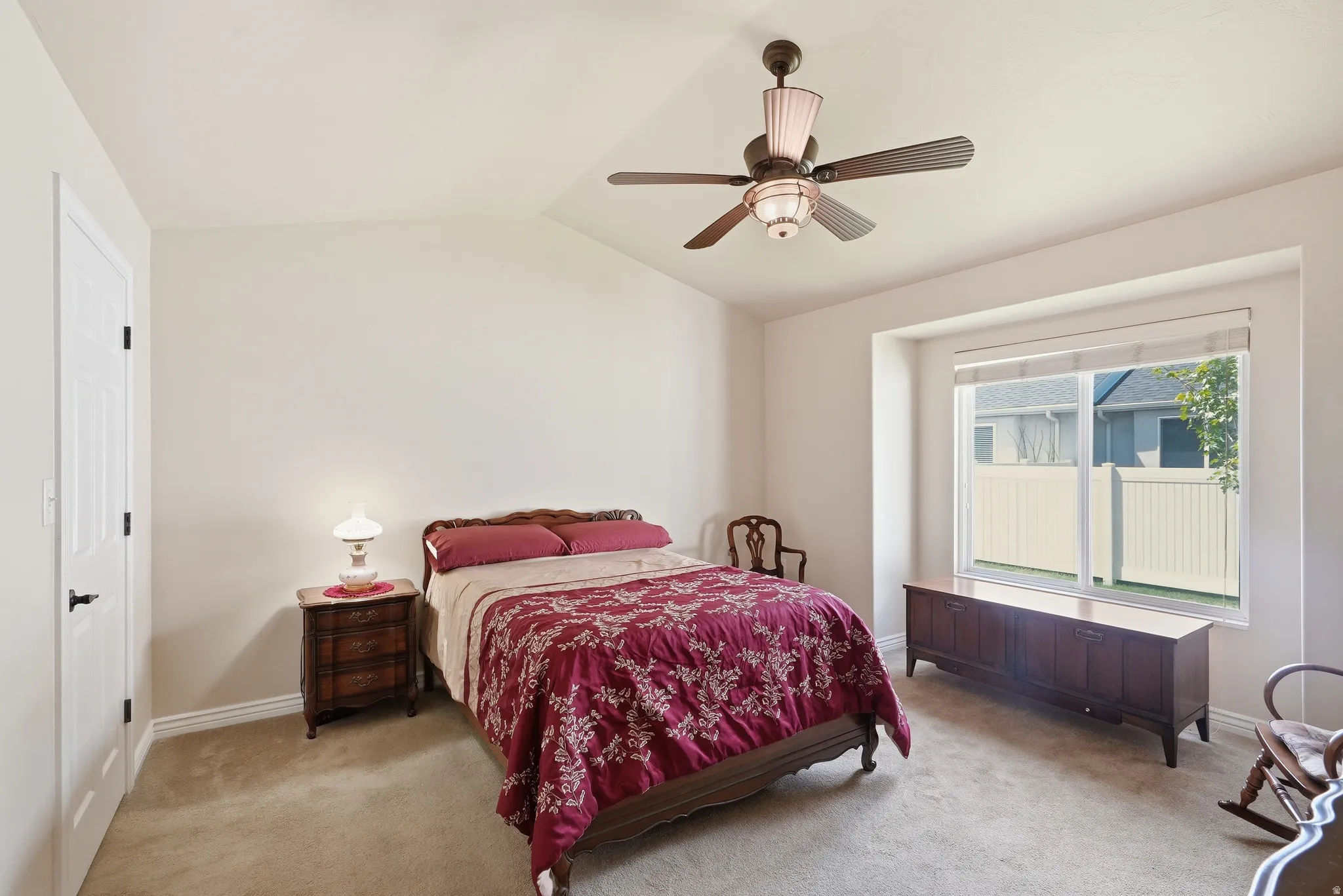 Bedroom featuring a vaulted ceiling and a ceiling fan with integrated lighting