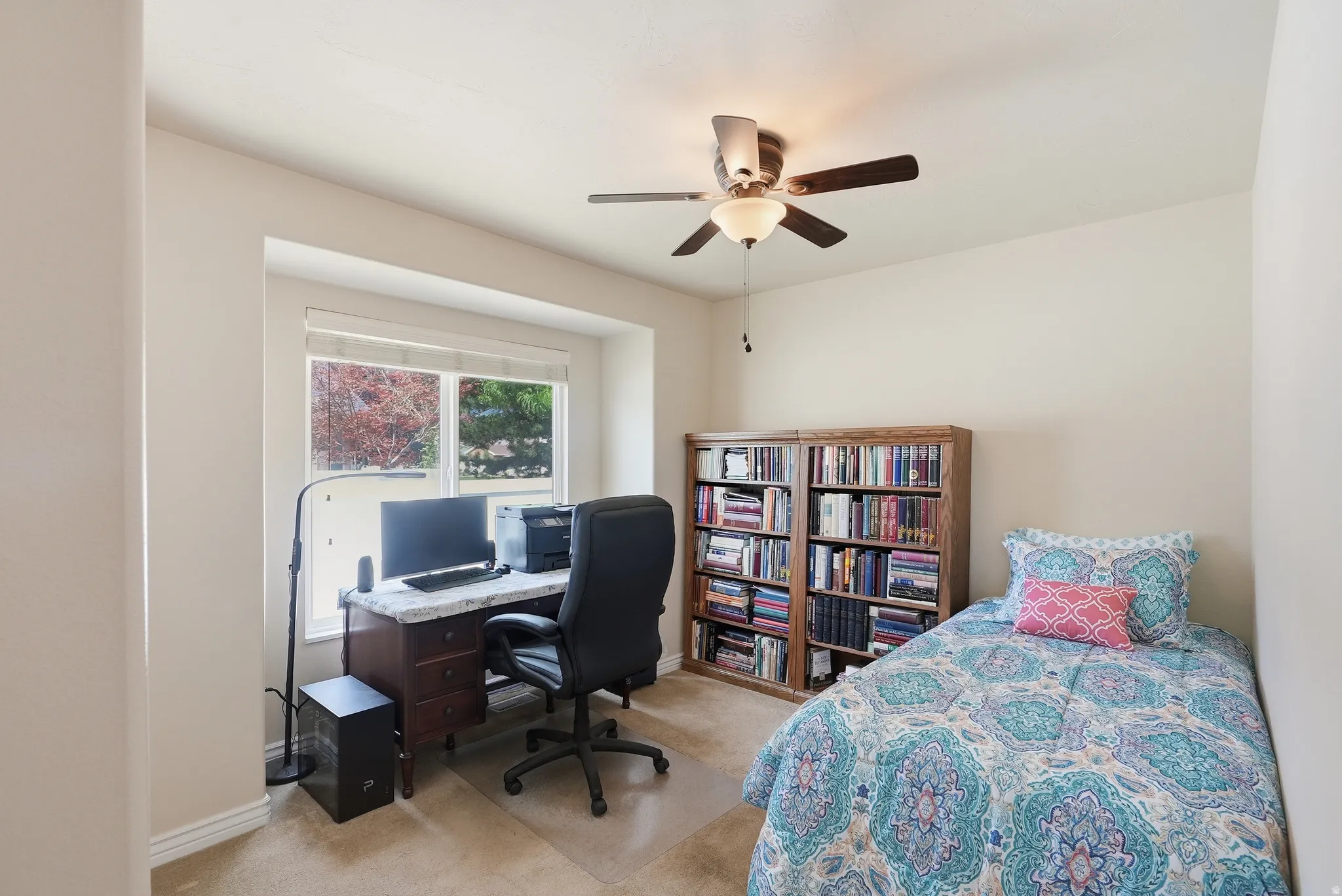 Recessed window area with a desk featuring a stone-finish countertop