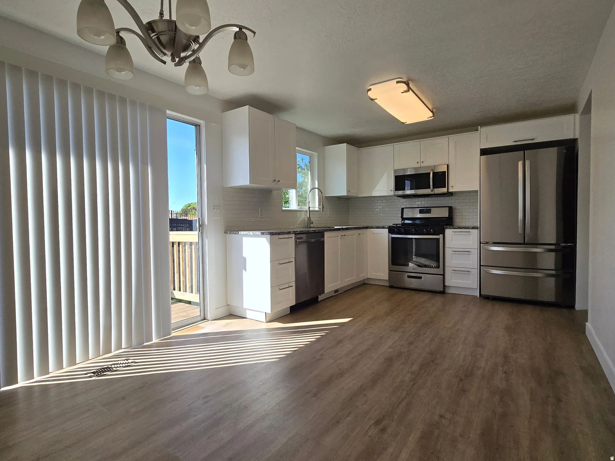 Open-concept kitchen with wood-finish flooring