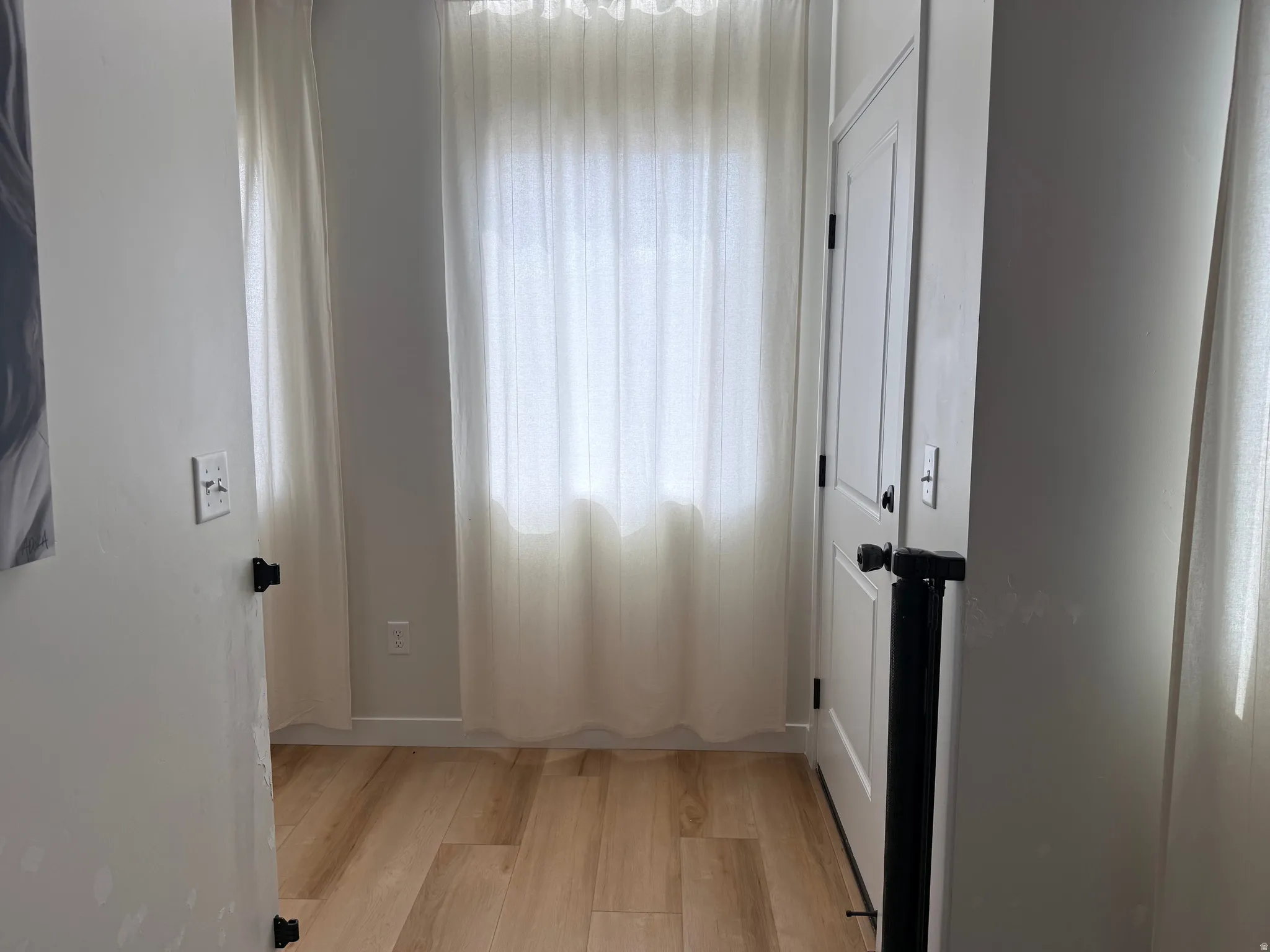 Light wood-finish flooring extending throughout the space