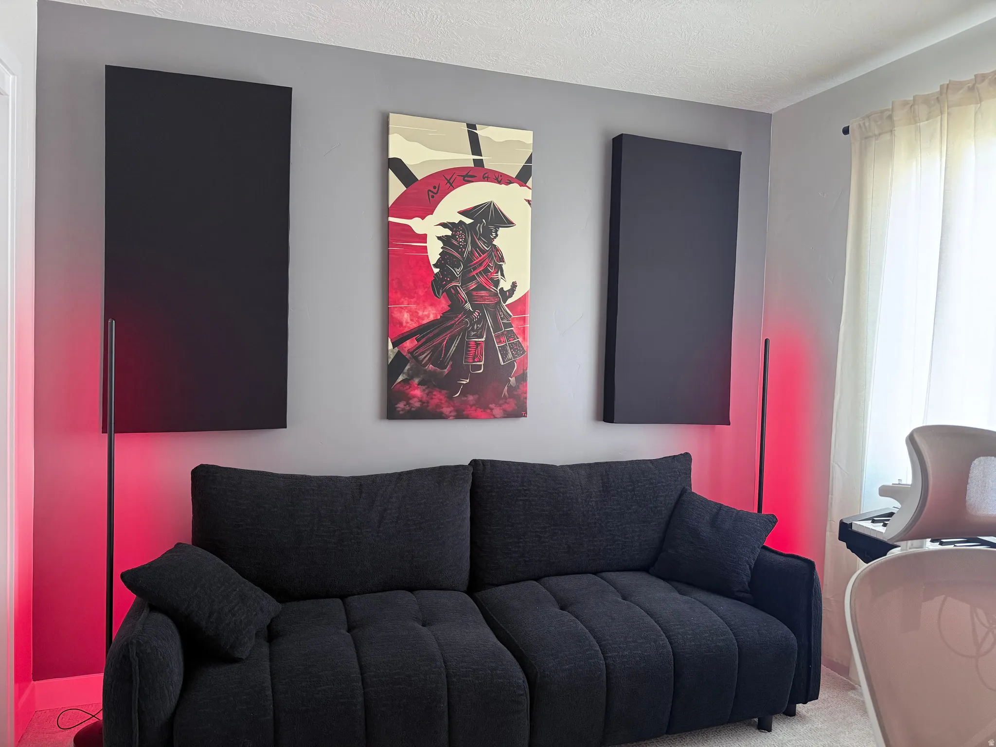 Gray wall with decorative acoustic panels and recessed lighting features