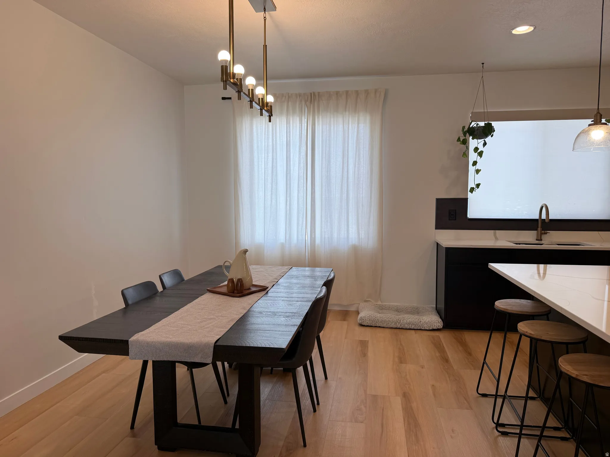 Open-concept dining area featuring light wood-finish flooring