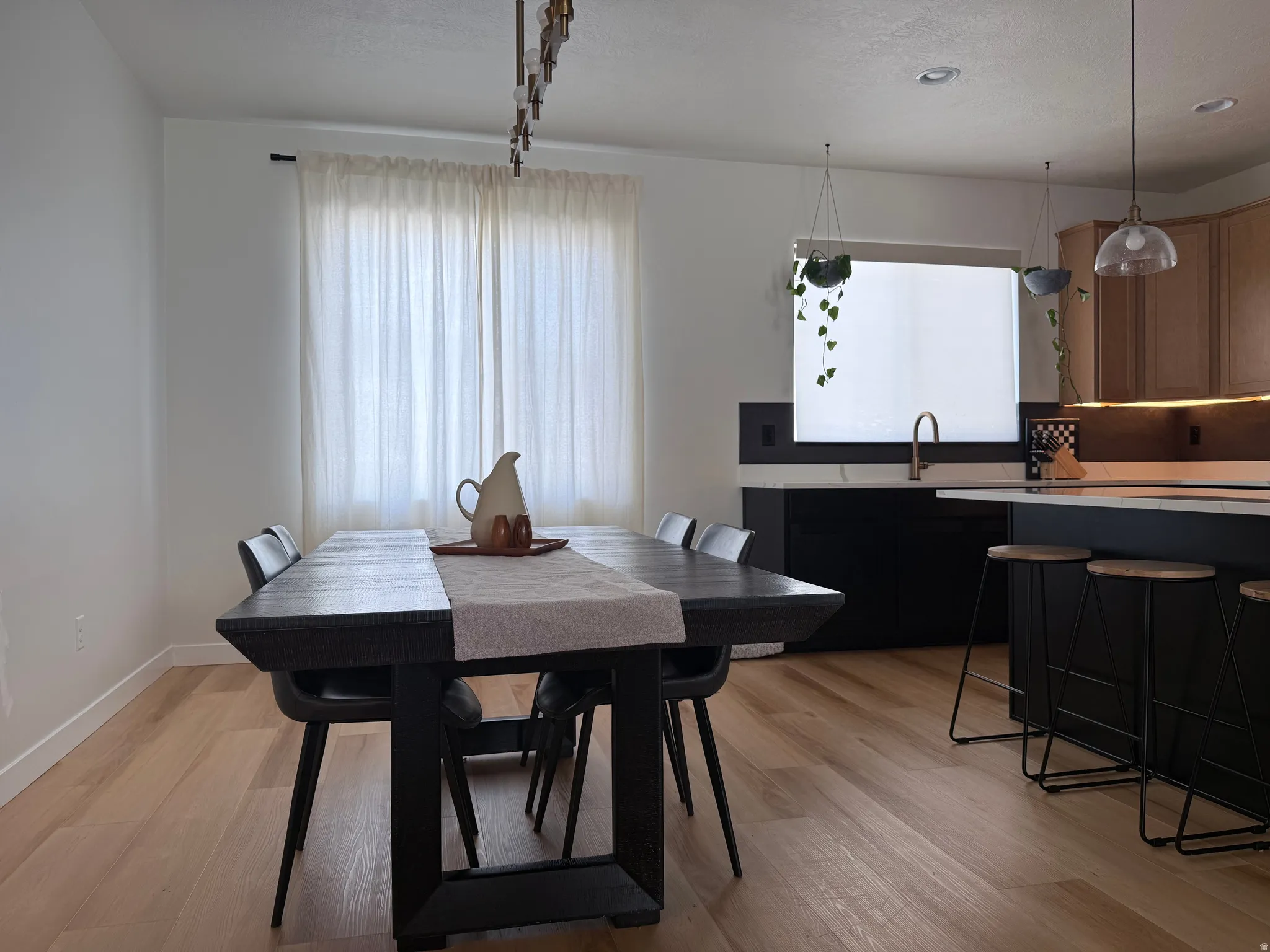 Open-concept living space with light wood-finish flooring