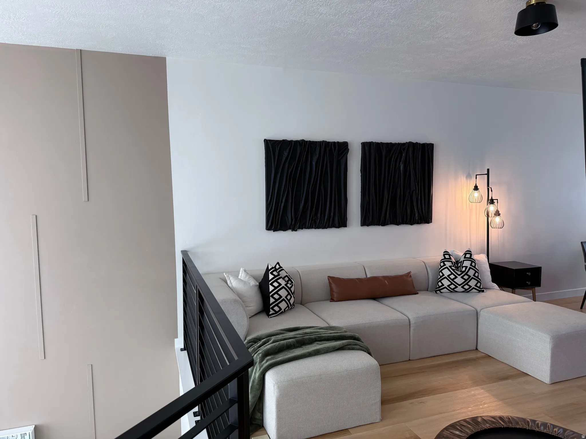 Open-concept living space with light wood-finish flooring