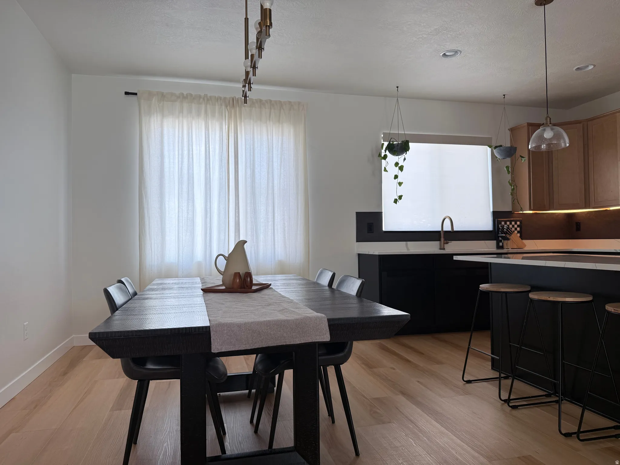 Open-concept dining area featuring light wood-finish flooring