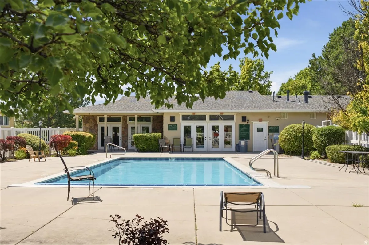 Outdoor swimming pool with integrated entry steps and surrounding concrete decking