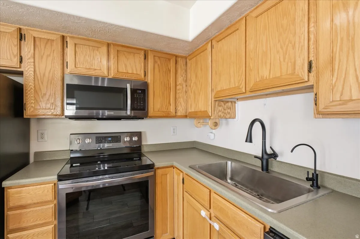Kitchen featuring light wood cabinetry and light-toned countertops
