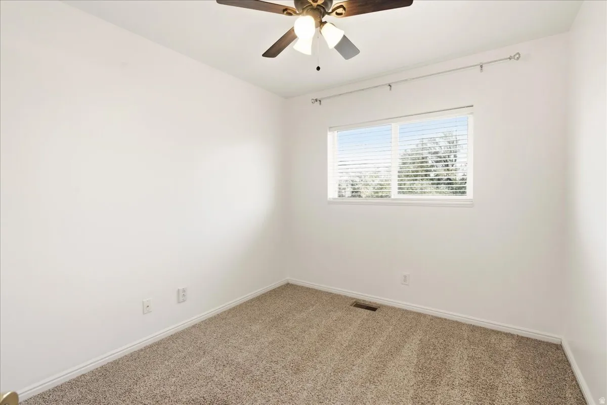 Neutral-toned carpeting paired with white baseboards and walls